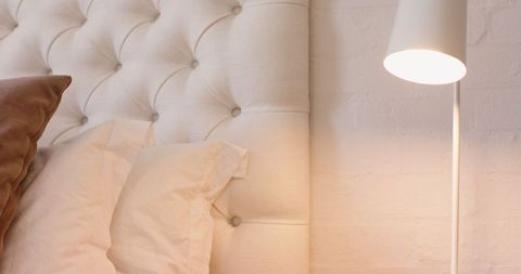 Cozy Bedroom with Tufted Headboard and Soft Ambiance Lighting