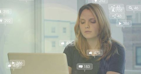 Woman engaged on laptop with social media interactions overlay