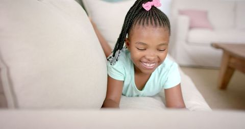 Joyful Girl with Braided Hair Enjoying Time at Home