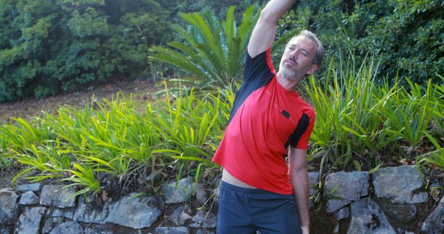 Middle-Aged Man Stretching Outdoors in Garden - Download Free Stock Images Pikwizard.com