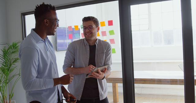 Coworkers Discussing Ideas in Modern Office with Glass Wall - Download Free Stock Images Pikwizard.com