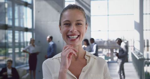 Confident Woman Smiling in Busy Corporate Office - Download Free Stock Images Pikwizard.com