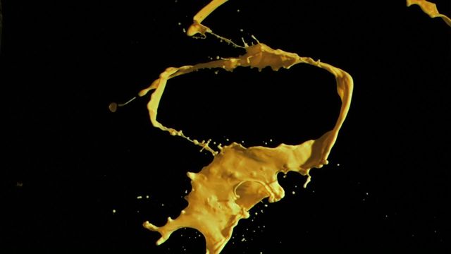 This scene features vibrant yellow paint in mid-air against a black backdrop, capturing the fluidity and movement in high detail for artistic and design uses. Ideal for backgrounds, advertisements emphasizing creativity, and dynamic motion elements in multimedia projects.