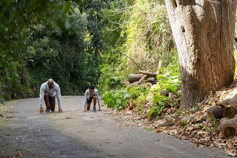 African american father and son preparing for sprint on wooded trail