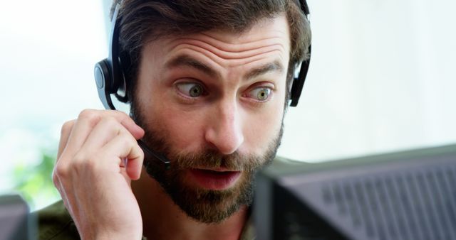 Customer service representative wearing headset, showing surprised expression while talking. Suitable for illustrating customer support roles, call center operations, business professionalism, and communication in corporate environments.