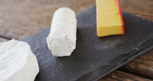 Assorted Cheeses on Slate Plate at Rustic Wooden Table - Download Free Stock Images Pikwizard.com