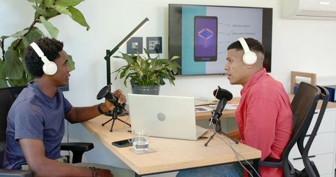 Diverse Colleagues Podcasting with Technology in Modern Conference Room