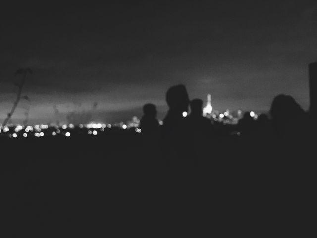 People Silhouetted Against Distant Cityscape at Night - Download Free Stock Photos Pikwizard.com