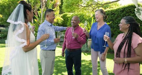 Joyful Senior Wedding Toast in Lush Garden Setting