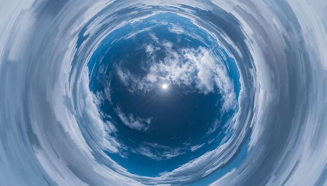 Surreal cloud vortex skyscape with sun at center