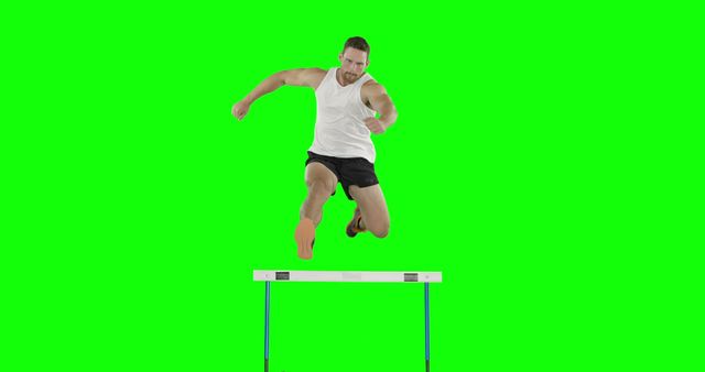 Athletic man jumping over hurdle with green screen background can be used for sports promotions, fitness instructions, or advertisements. Perfect for creating dynamic exercise videos, instructional guides, or sports performance montages. Green screen background allows for easy customization and overlays.