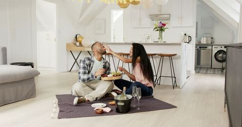 Couple Celebrating at Home with Wine, Food and Joyful Moment