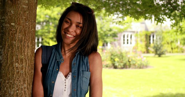 Smiling Woman Standing Near Tree in Sunny Garden - Download Free Stock Images Pikwizard.com