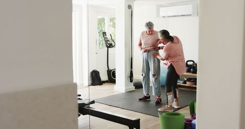 Senior Lesbian Couple Enjoying Home Workout Together at Gym