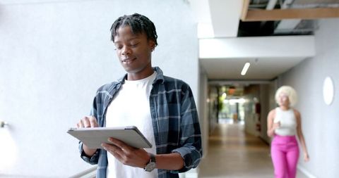 Focused professional using digital tablet in modern office environment