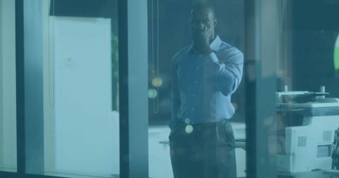 African American Businessman Contemplating Nighttime Office