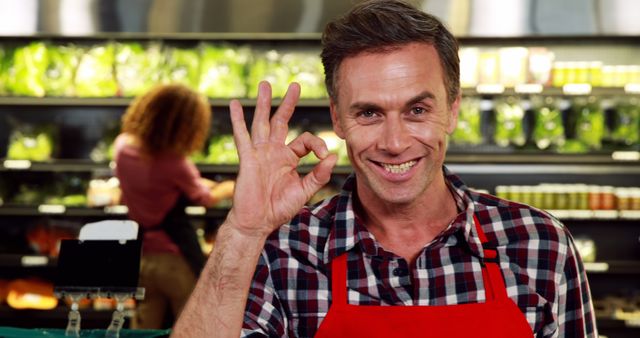 Smiling Grocery Store Worker Making OK Sign - Download Free Stock Images Pikwizard.com