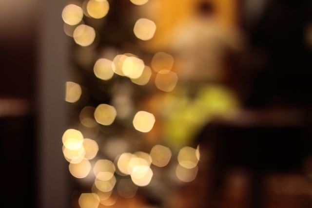 Ideal for use as a background during holiday season promotions, festive greeting card designs, or Christmas-themed social media posts. The blurred and glowing lights evoke a warm and joyful atmosphere, perfect for adding a touch of holiday cheer to any project.