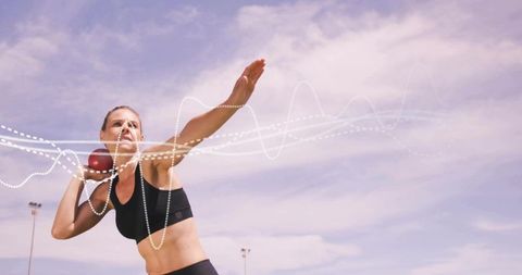 Female Shot Put Athlete Preparing Throw on Outdoor Track with Motion Trail Effect