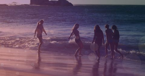 Teen Girls Enjoying Sunset Beach Walk in Summer Glow