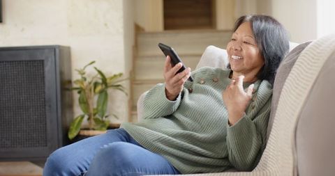 Content Chinese Woman Using Smartphone at Home