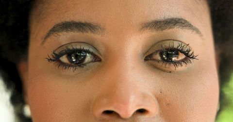 Close-up of Woman Gazing Thoughtfully with Eye Makeup
