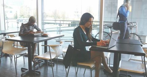 Businesswoman Typing in Modern Workspace with Terrace View