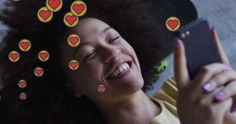 African American Woman Smiling While Using Smartphone