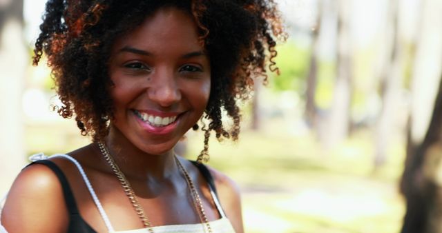 Smiling Young African American Woman Outdoors in Warm Sunlight - Download Free Stock Images Pikwizard.com