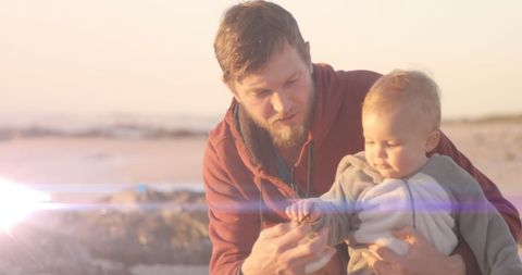 Loving Father Bonding with Baby at Tranquil Beach Sunset