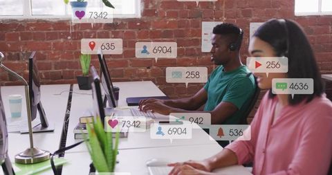 Customer Support Team Typing at Open-Plan Desk with Social Media Notification Overlays