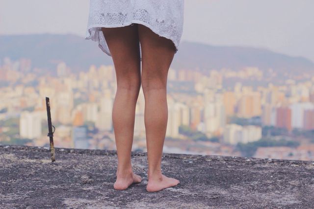 Woman Standing Barefoot in Urban Overlook - Download Free Stock Photos Pikwizard.com