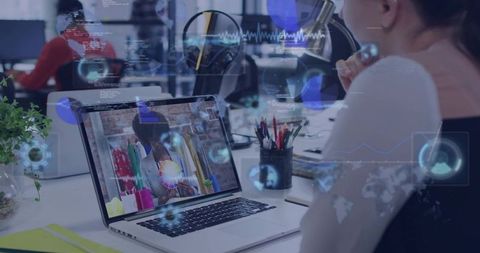 Woman watching virtual clothing demo on laptop with AR overlays in modern office workspace