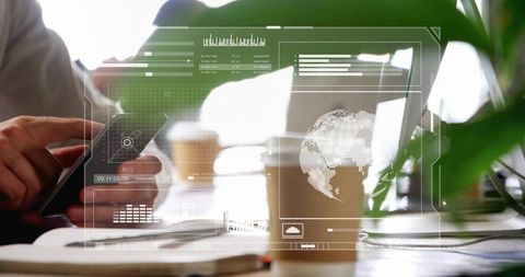 Hands holding smartphone tapping with laptop, coffee showing ar data overlay