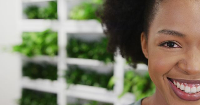 Close-Up of Smiling African American Woman With Green Plants On Background - Download Free Stock Images Pikwizard.com