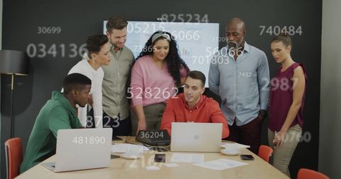 Diverse Team Collaborating on Data and Technology in Meeting Room