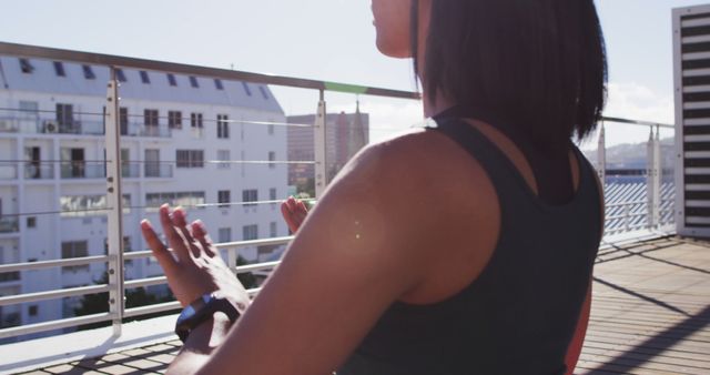 Woman Meditating on Apartment Balcony in Morning Sunlight - Download Free Stock Images Pikwizard.com