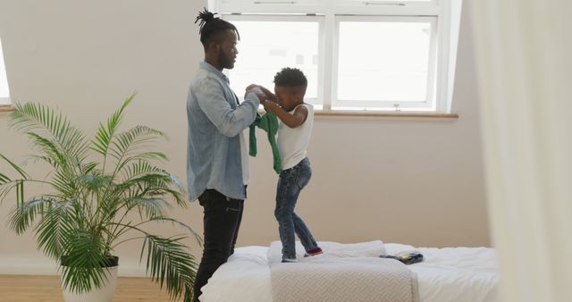 Father Playing with Child in Bright Modern Bedroom - Download Free Stock Images Pikwizard.com