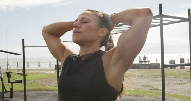 Fit woman relaxing outdoors on a sunny day at the beach - Download Free Stock Images Pikwizard.com