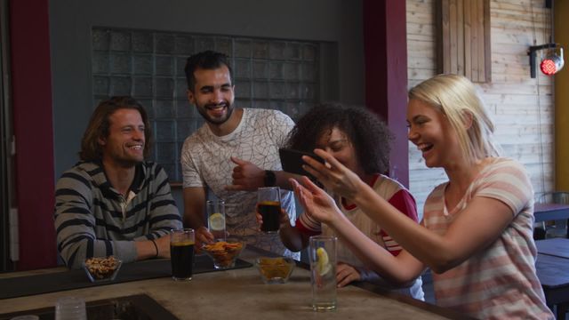 Group of diverse friends enjoying time together at a pub during the day. Perfect for themes related to friendship, socializing, modern lifestyle, leisure activities, and youth culture. Can be used in marketing for bars, social apps, or lifestyle promotions.