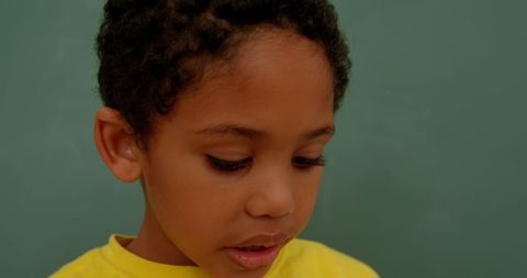 Contemplative Schoolboy Against Chalkboard in Classroom - Download Free Stock Images Pikwizard.com