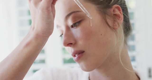 Woman Applying Serum to Face for Skincare Routine - Download Free Stock Images Pikwizard.com