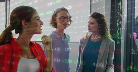 Professional women collaborating on finance strategy in modern office