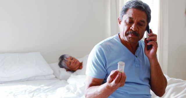 Senior Man Calling Doctor While Examining Prescription Bottle - Download Free Stock Images Pikwizard.com