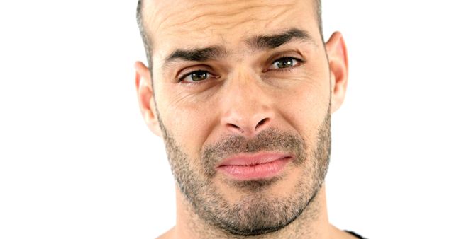 Man showing sceptical expression, visible emotions through facial cues. Suitable for concepts of doubt, uncertainty, human emotions, personal reaction. Can be used in articles, blogs, websites about psychology, social interactions, communication.