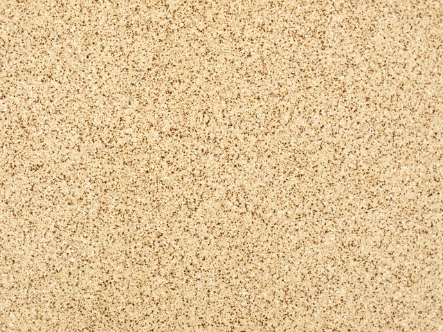 Photo shows a close-up of a brown speckled tile texture, ideal for use in architecture and interior design projects. Perfect for backgrounds, flooring samples, and construction material references.