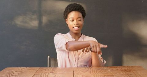 Confident african american businesswoman gesturing in office
