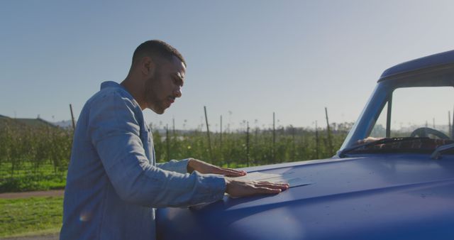 Man Inspecting Hood of Classic Blue Truck Outdoors - Download Free Stock Images Pikwizard.com