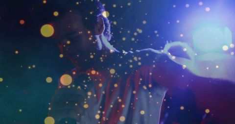 Singing performer holding microphone under cinematic bokeh lights and hazy club atmosphere