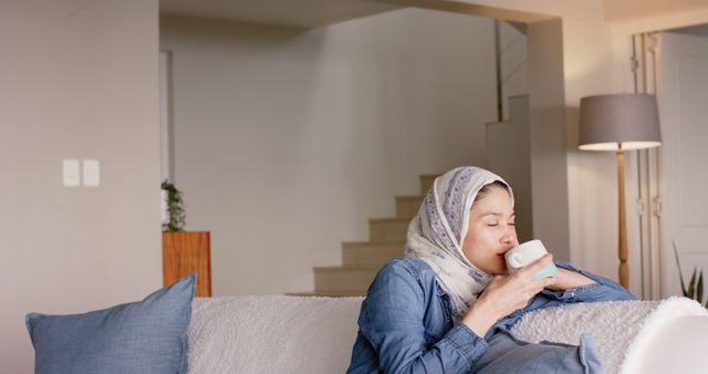 Woman Relaxing on Sofa with Coffee in Cozy Living Room - Download Free Stock Images Pikwizard.com